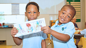 two students holding a drawing